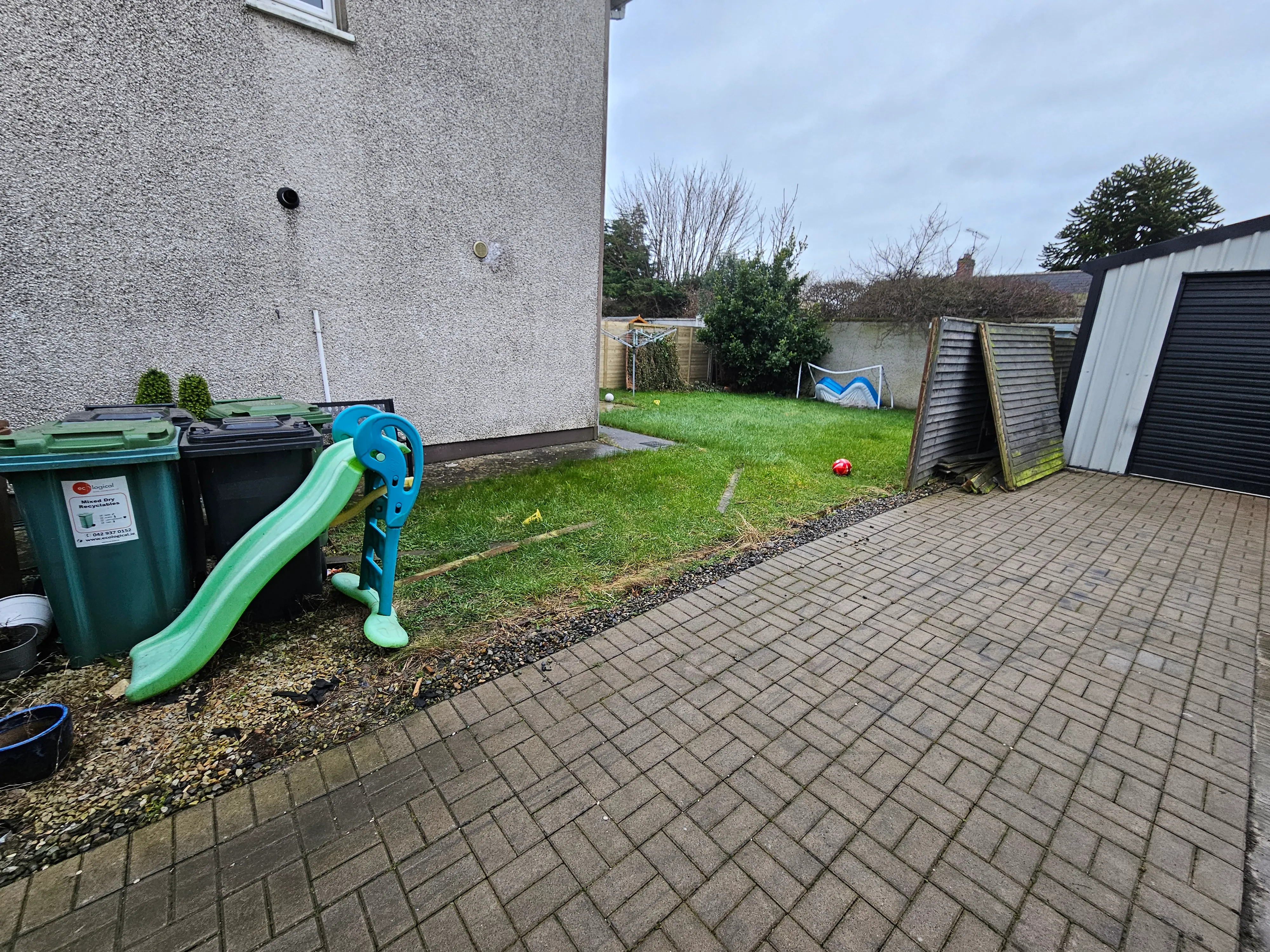 A garden pathway with established lawn areas on either side